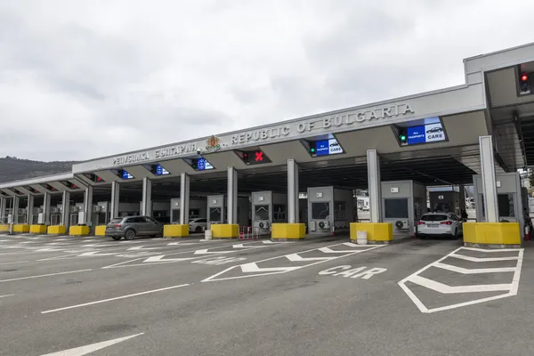 Republic of Bulgaria border crossing at Kalotina with row of passport control booths, EU/EEA/CH and All Passports lane indicators, yellow concrete barriers and clearly marked CAR lane on A6/E79 motorway from Serbia, March 2026